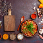 top-view-delicious-cooked-vegetables-sliced-with-different-seasonings-dark-background-soup-food-sauce-meal-vegetable (1)